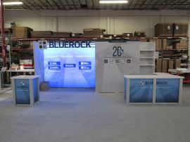 Custom Modular Inline Exhibit with Backlit Graphics, Header with Dimensional Letters, Closet with Locking Storage, Shelves, Large L-Shaped Counter with Storage, and Pedestal with Locking Storage (similar to RE-1222)